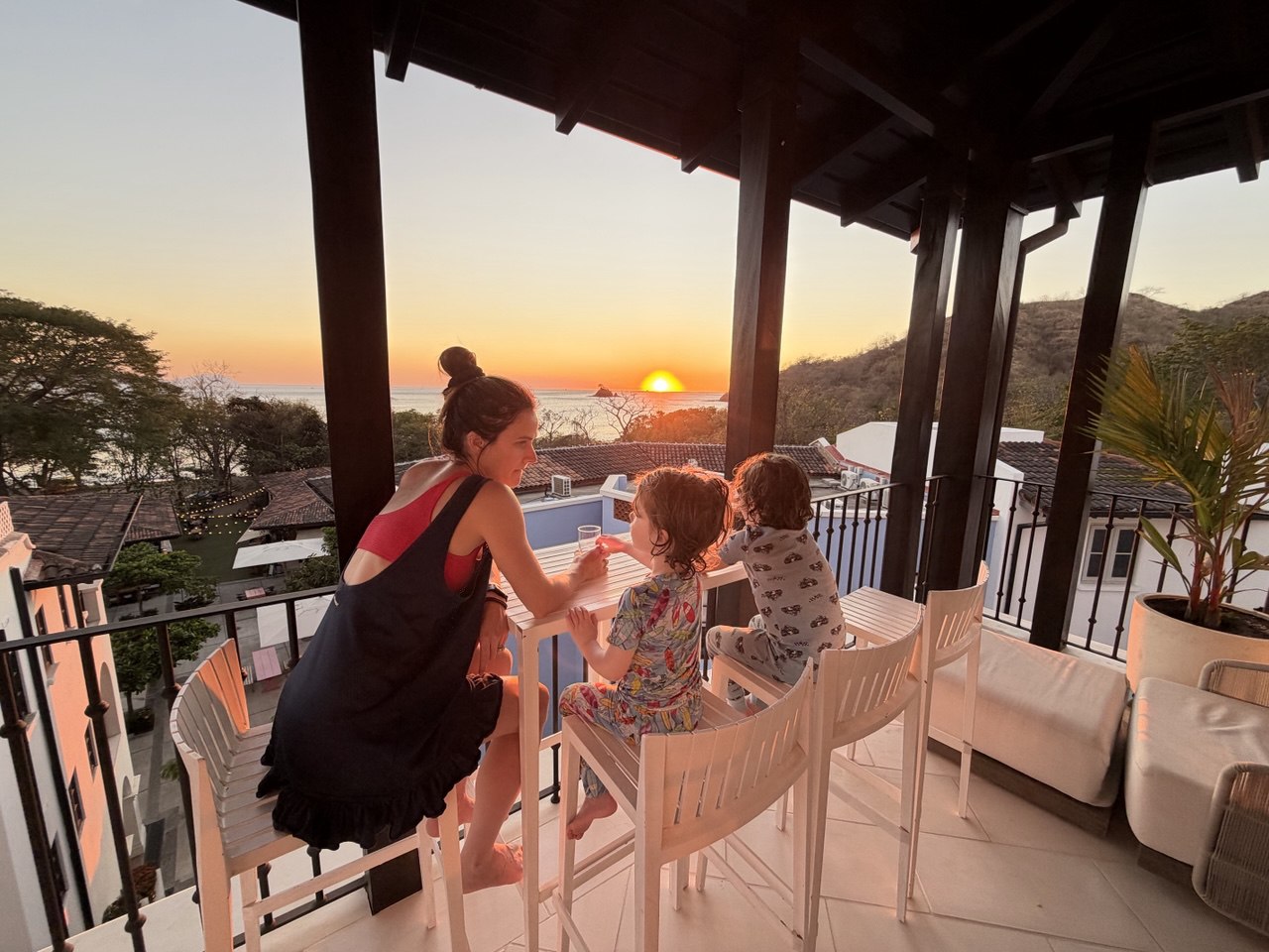 Courtney and boys watching sunset from the balcony in Costa Rica